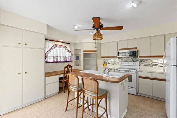 a open kitchen with stainless steel appliances granite countertop a sink and a refrigerator