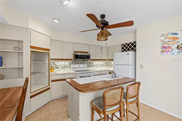 a kitchen with stainless steel appliances kitchen island granite countertop a refrigerator and a stove top oven