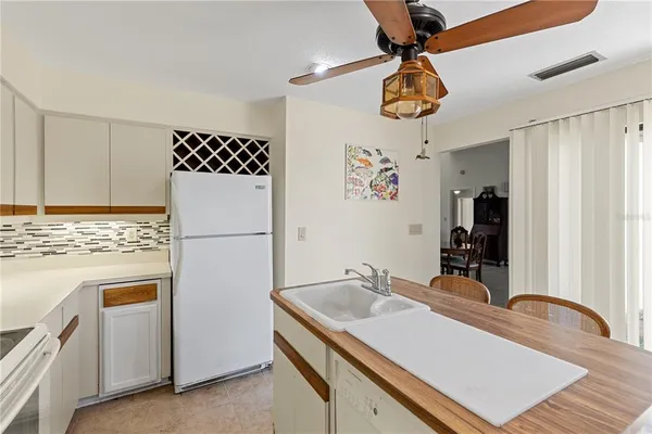a kitchen with stainless steel appliances granite countertop a sink a refrigerator and a stove