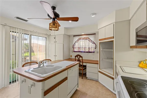 a kitchen with a sink appliances and a counter top space