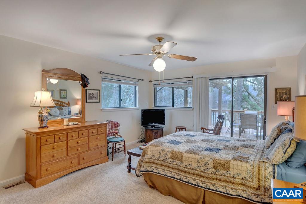 3 Laguna Road Palmyra, VA 22963 - Photo 15 of 39 a bedroom with a large bed and a chandelier
