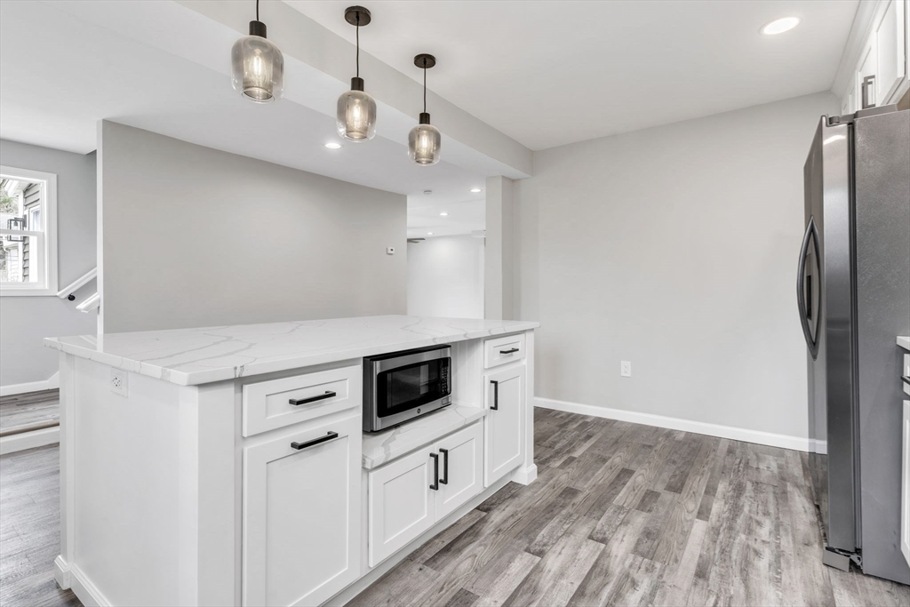 74 Ruggles Street Three Rivers, MA 01080 - Photo 14 of 42 a kitchen with stainless steel appliances a stove oven and a refrigerator