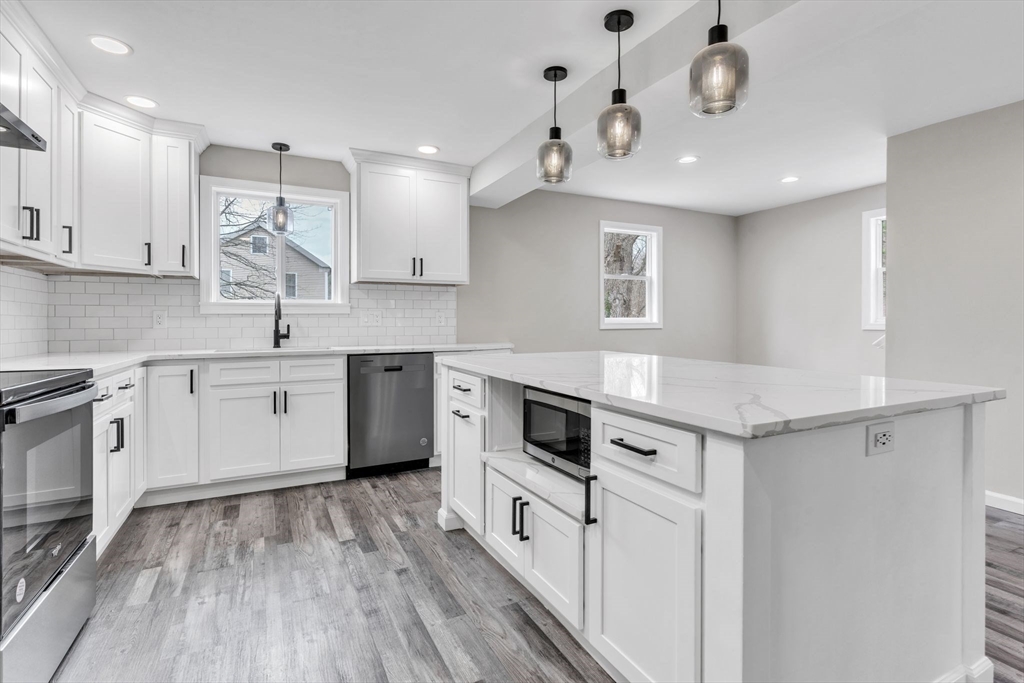 74 Ruggles Street Three Rivers, MA 01080 - Photo 15 of 42 a kitchen with a sink a counter top space stainless steel appliances and cabinets