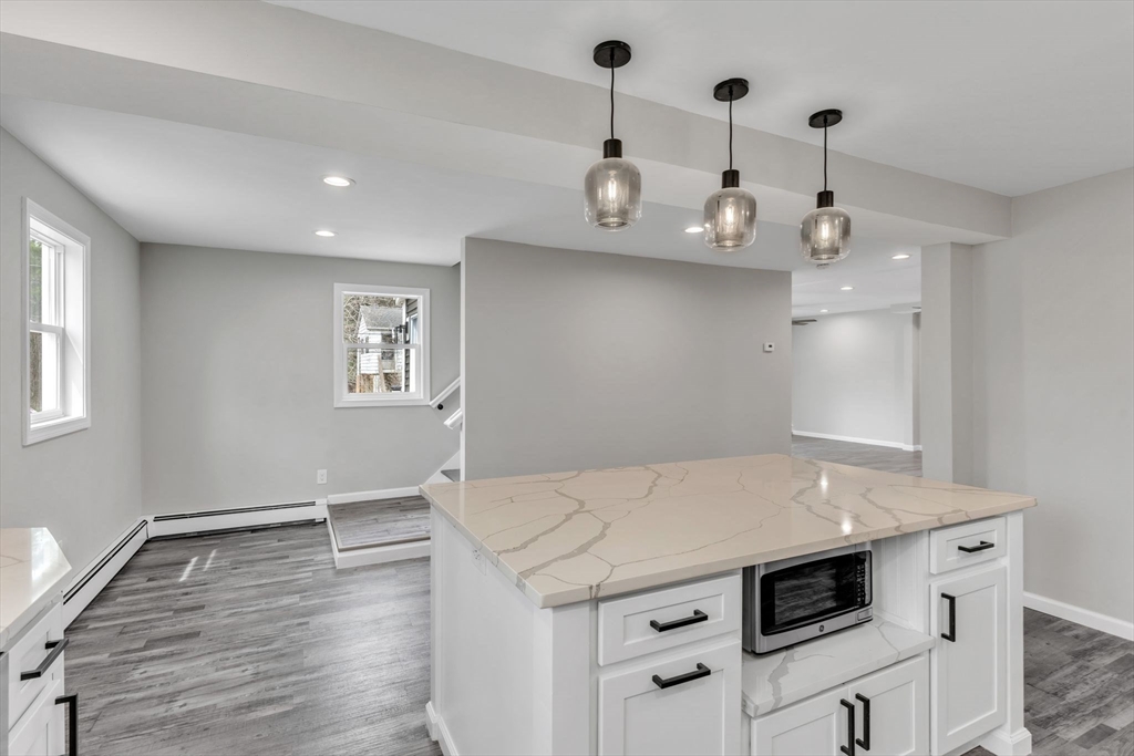 74 Ruggles Street Three Rivers, MA 01080 - Photo 17 of 42 a kitchen with a stove and a wooden floor