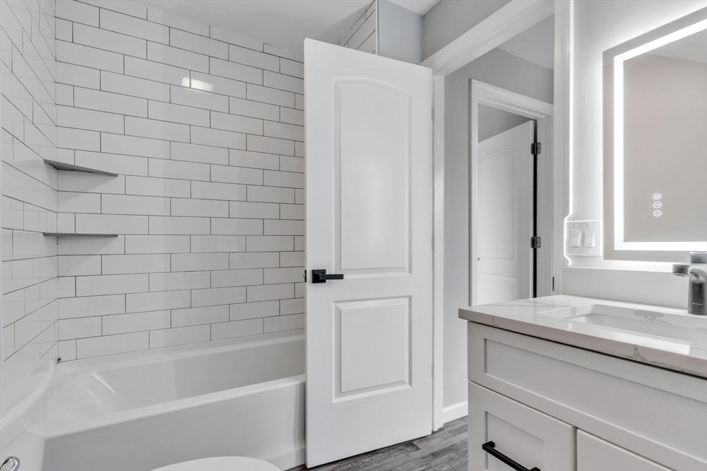 74 Ruggles Street Three Rivers, MA 01080 - Photo 33 of 42 a bathroom with a granite countertop bathtub shower sink and mirror