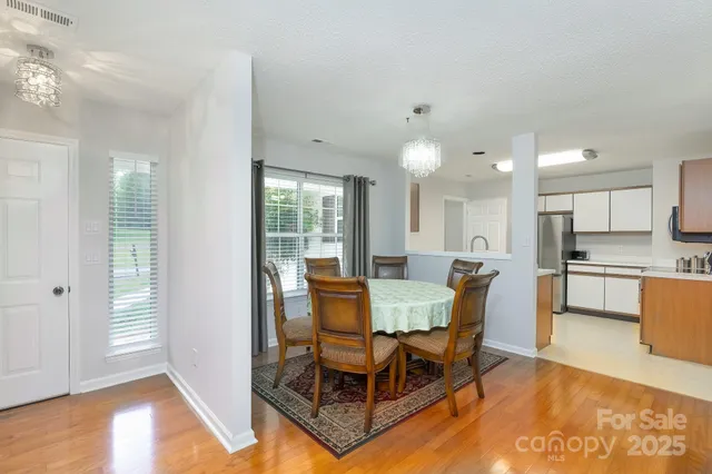 a dining room with furniture and wooden floor