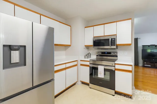 a kitchen with stainless steel appliances a refrigerator stove and microwave