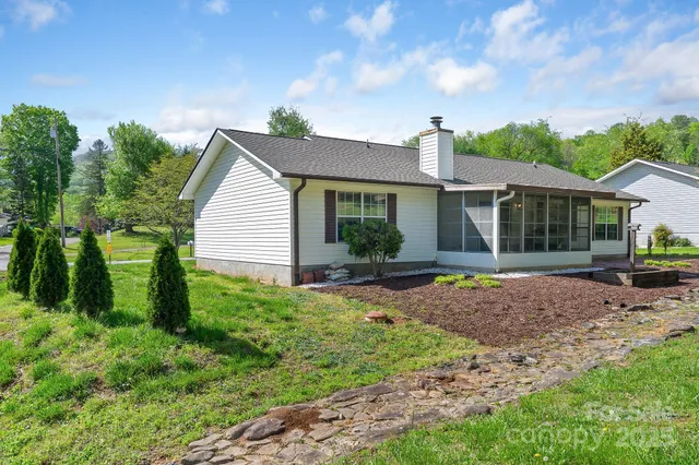 a view of a house with backyard and porch