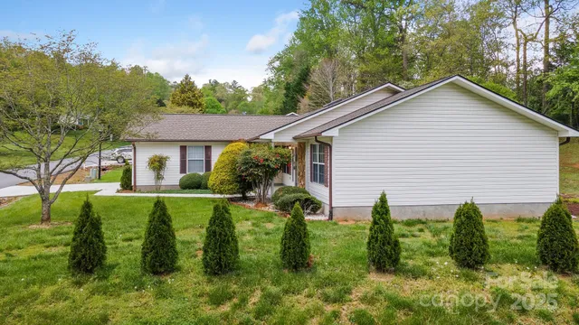 a front view of house with a garden