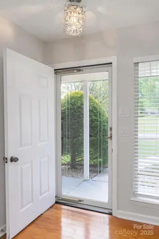 a view of a livingroom with wooden floor and a large window