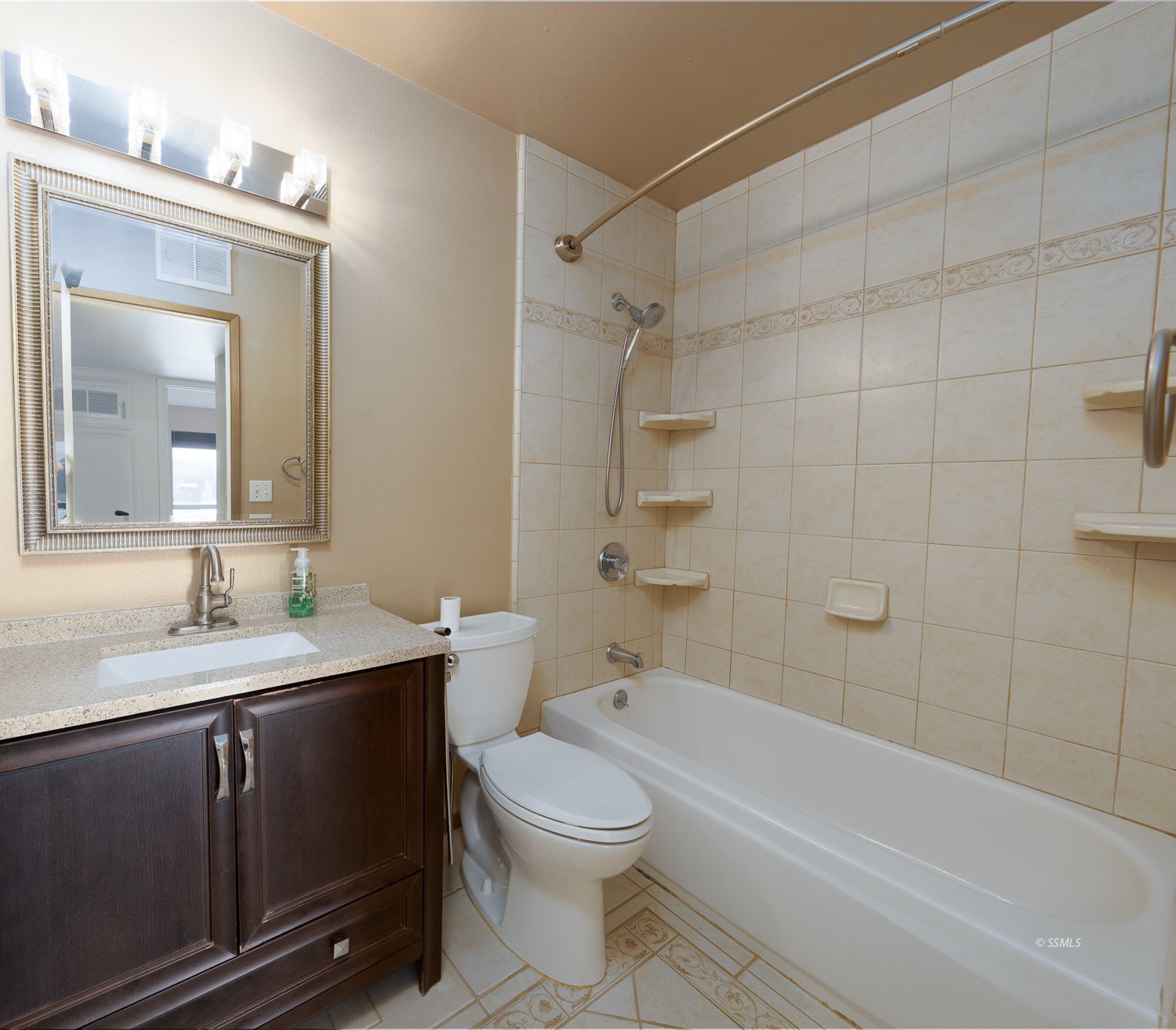 309 Mari Court Ridgecrest, CA 93555 - Photo 19 of 32 a bathroom with a toilet a sink a mirror a bathtub and shower