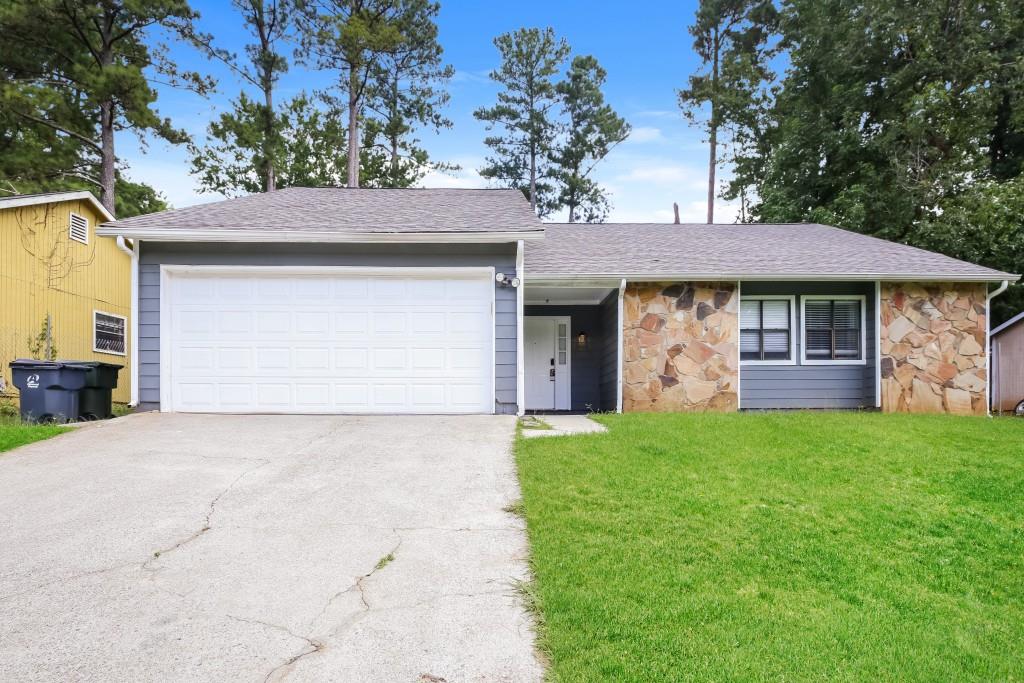 5056 Rails Way Norcross, GA 30071 - Photo 1 of 1 a front view of a house with a garden and trees