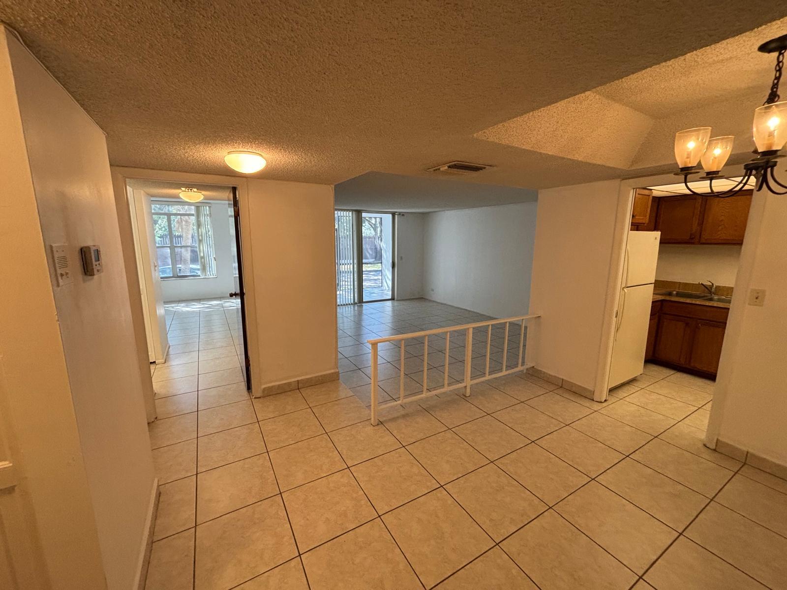 3650 Inverrary Drive, Unit 1K Lauderhill, FL 33319 - Photo 1 of 13 a view of a refrigerator in kitchen and wooden floor