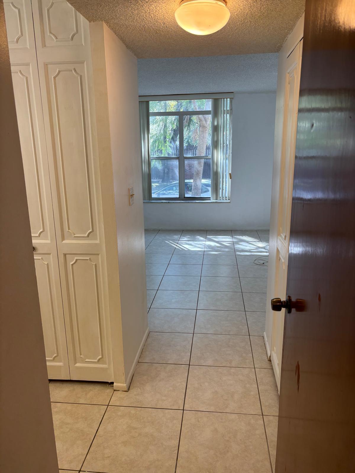 3650 Inverrary Drive, Unit 1K Lauderhill, FL 33319 - Photo 11 of 13 a view of hallway with granite countertop cabinets