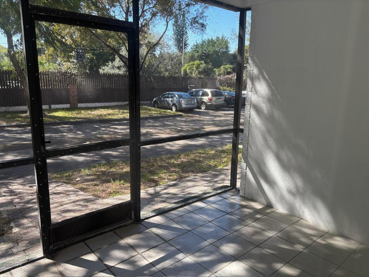 3650 Inverrary Drive, Unit 1K Lauderhill, FL 33319 - Photo 13 of 13 a view of a room with wooden floor and a floor to ceiling window