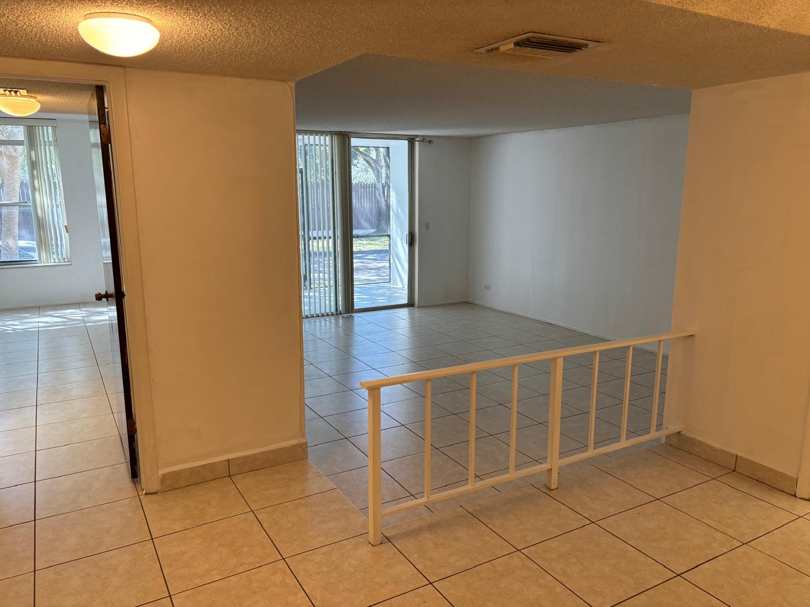 3650 Inverrary Drive, Unit 1K Lauderhill, FL 33319 - Photo 5 of 13 a view of an empty room with wooden floor and a window