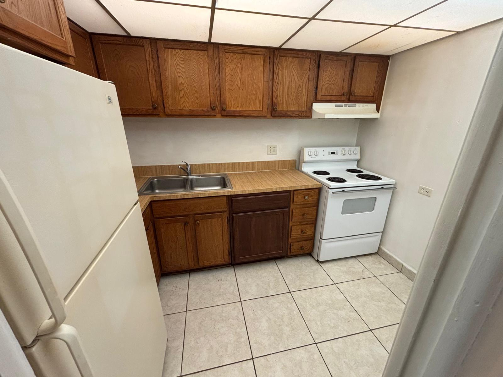 3650 Inverrary Drive, Unit 1K Lauderhill, FL 33319 - Photo 6 of 13 a kitchen with stainless steel appliances a stove a sink a counter top space and cabinets