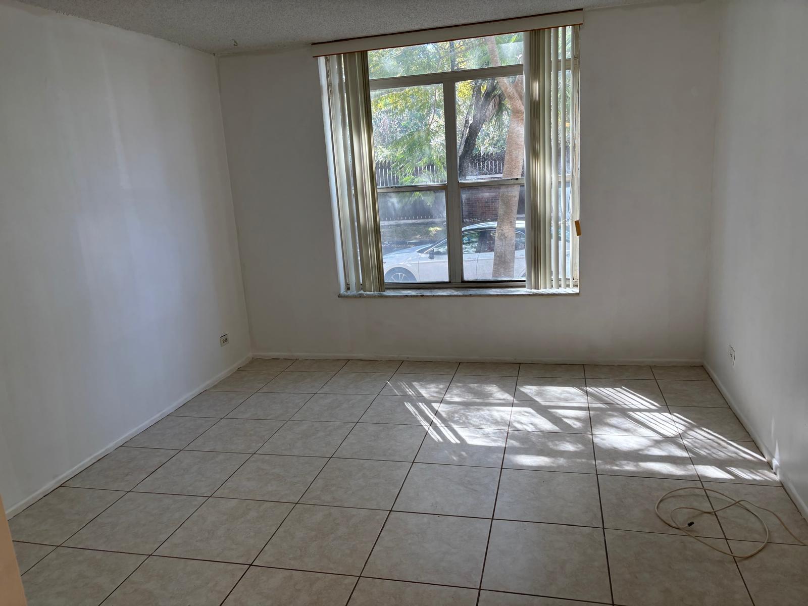3650 Inverrary Drive, Unit 1K Lauderhill, FL 33319 - Photo 8 of 13 a view of an empty room and window