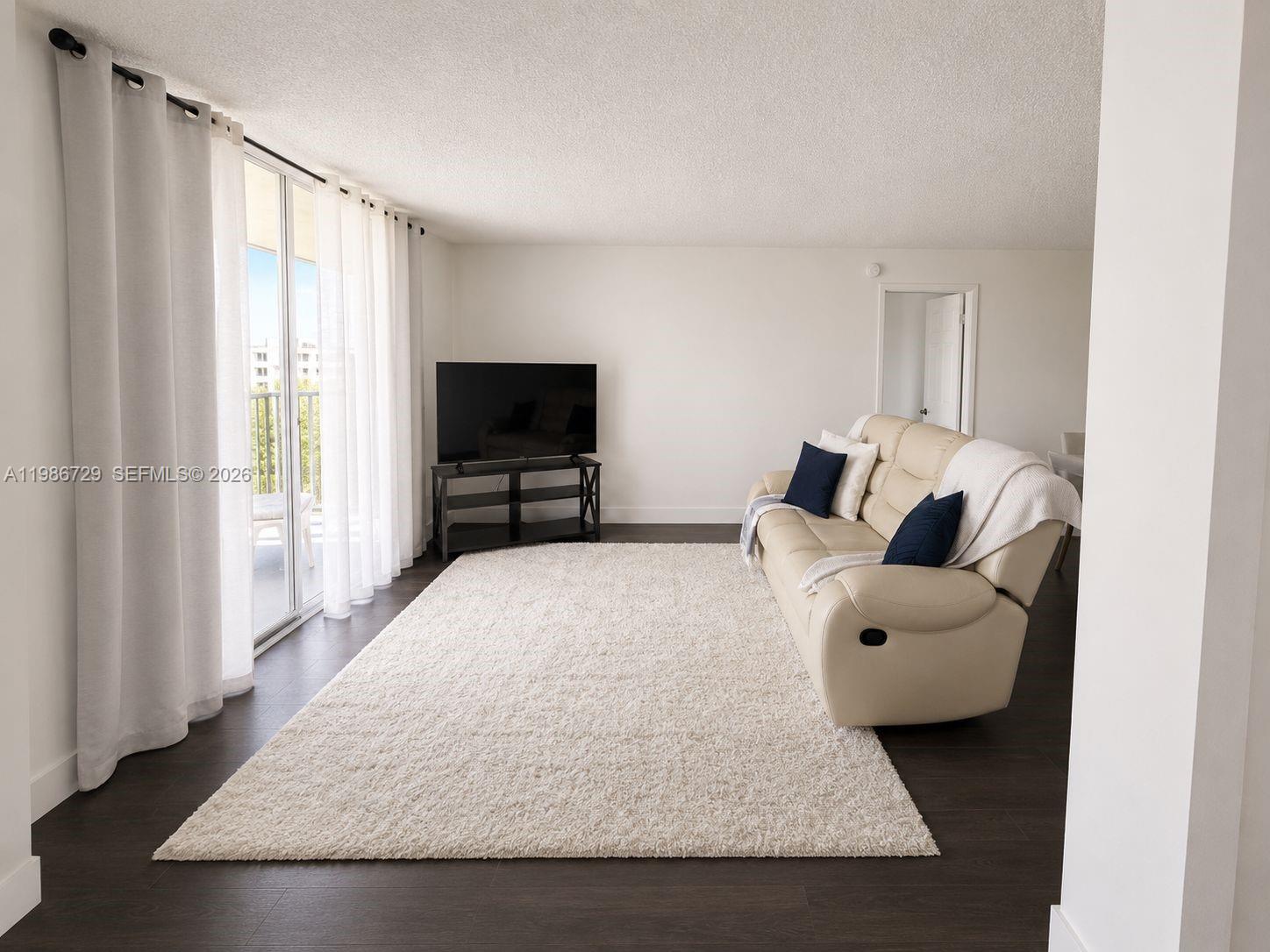 299 Northwest 52nd Terrace, Unit PHX Boca Raton, FL 33487 - Photo 10 of 16 a living room with furniture and a flat screen tv