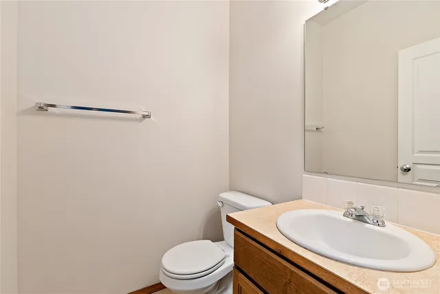 a bathroom with a sink a toilet and mirror
