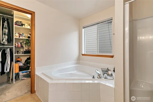 a bathroom with a tub sink and a mirror