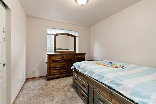 a bedroom with a bed and a dresser