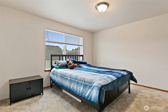 a bedroom with a bed and window