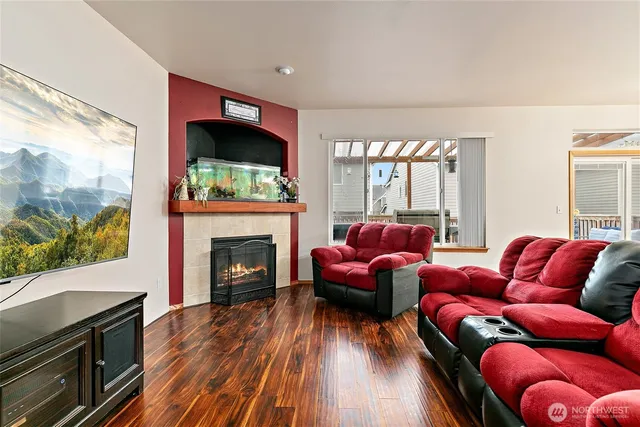 a living room with furniture fireplace and flat screen tv