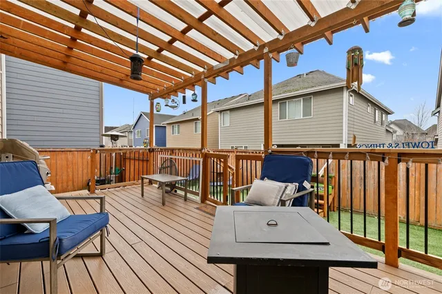 a view of a roof deck with table and chairs couches with wooden floor