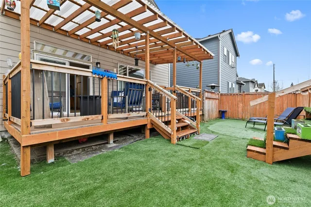 a view of a house with a backyard and a deck