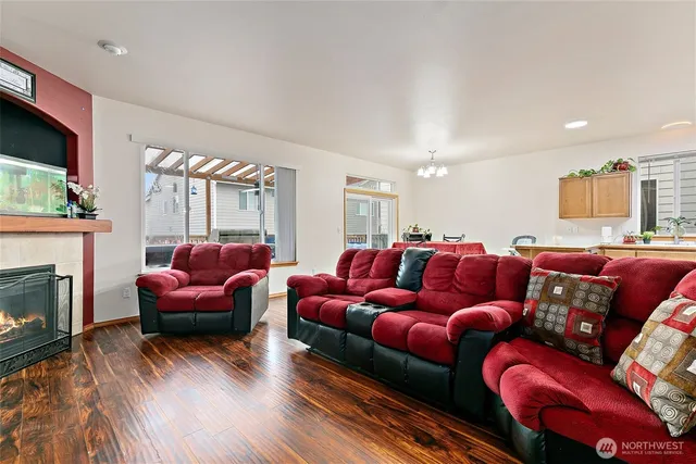 a living room with furniture a fireplace and a flat screen tv