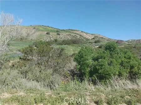 a view of a mountain range with lush green forest