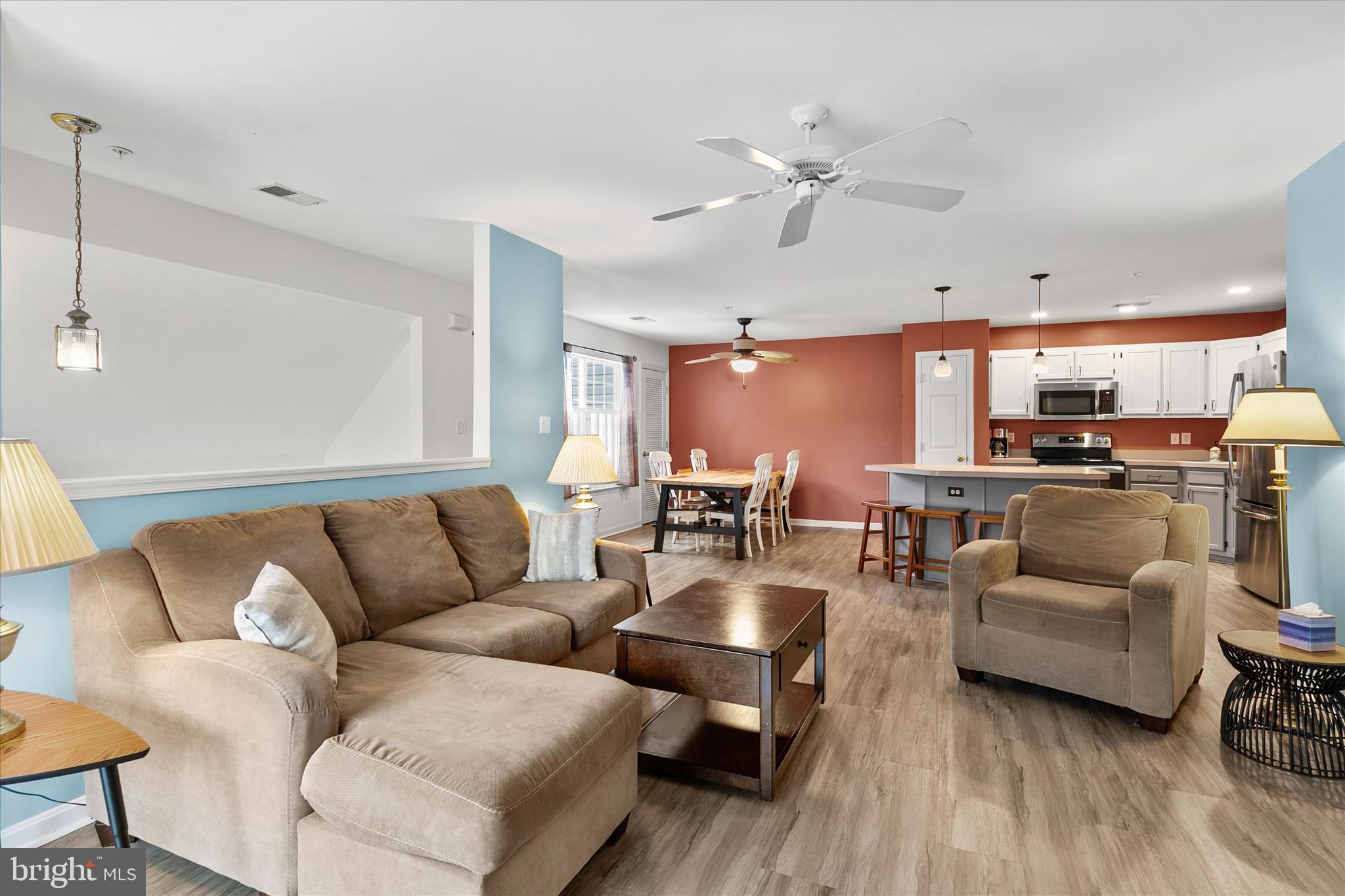 11423 Manklin Creek Road, Unit 1 Ocean Pines, MD 21811 - Photo 14 of 40 a living room with furniture kitchen view and a chandelier
