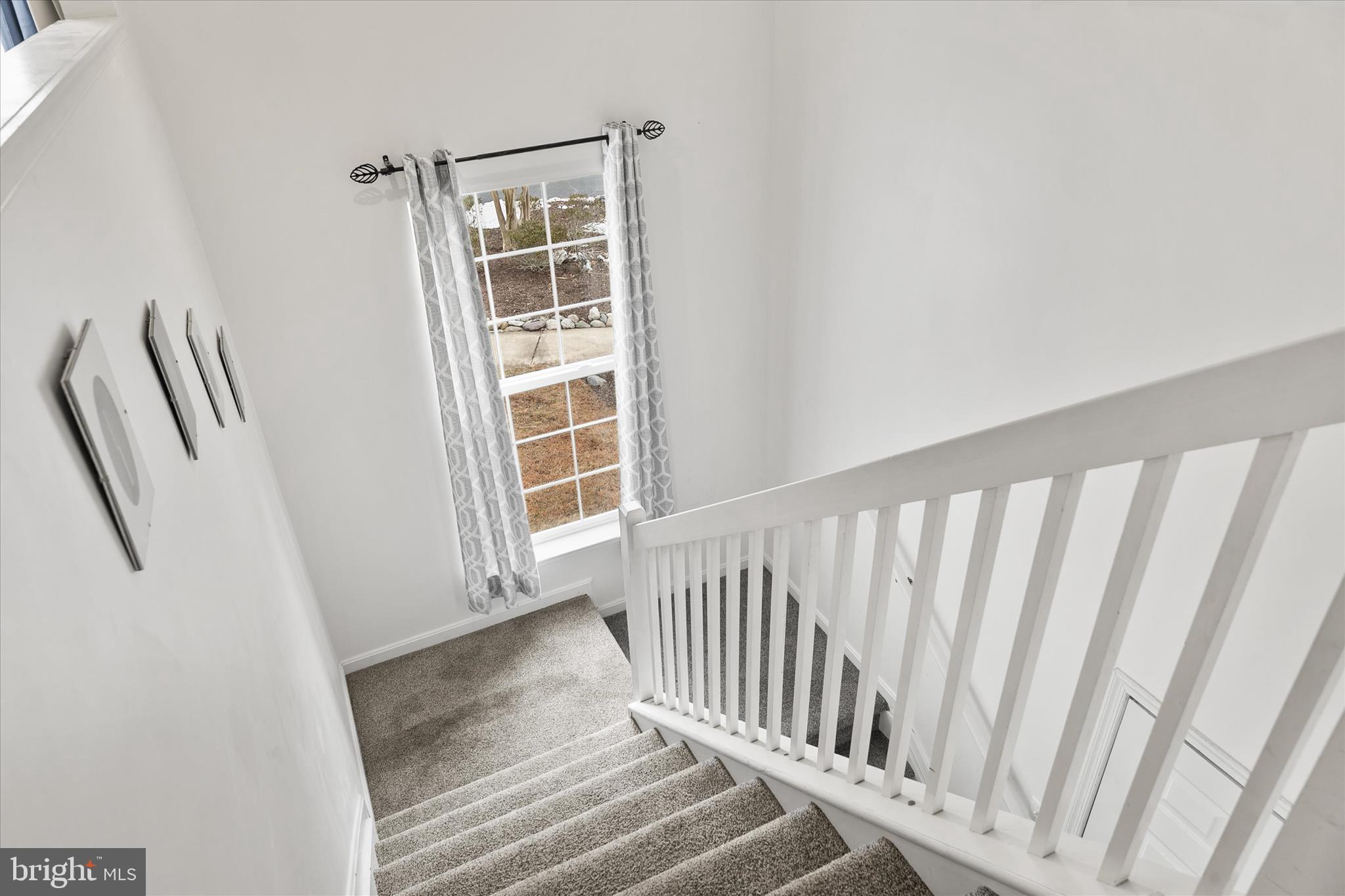 11423 Manklin Creek Road, Unit 1 Ocean Pines, MD 21811 - Photo 15 of 40 a view of staircase with white walls and a window