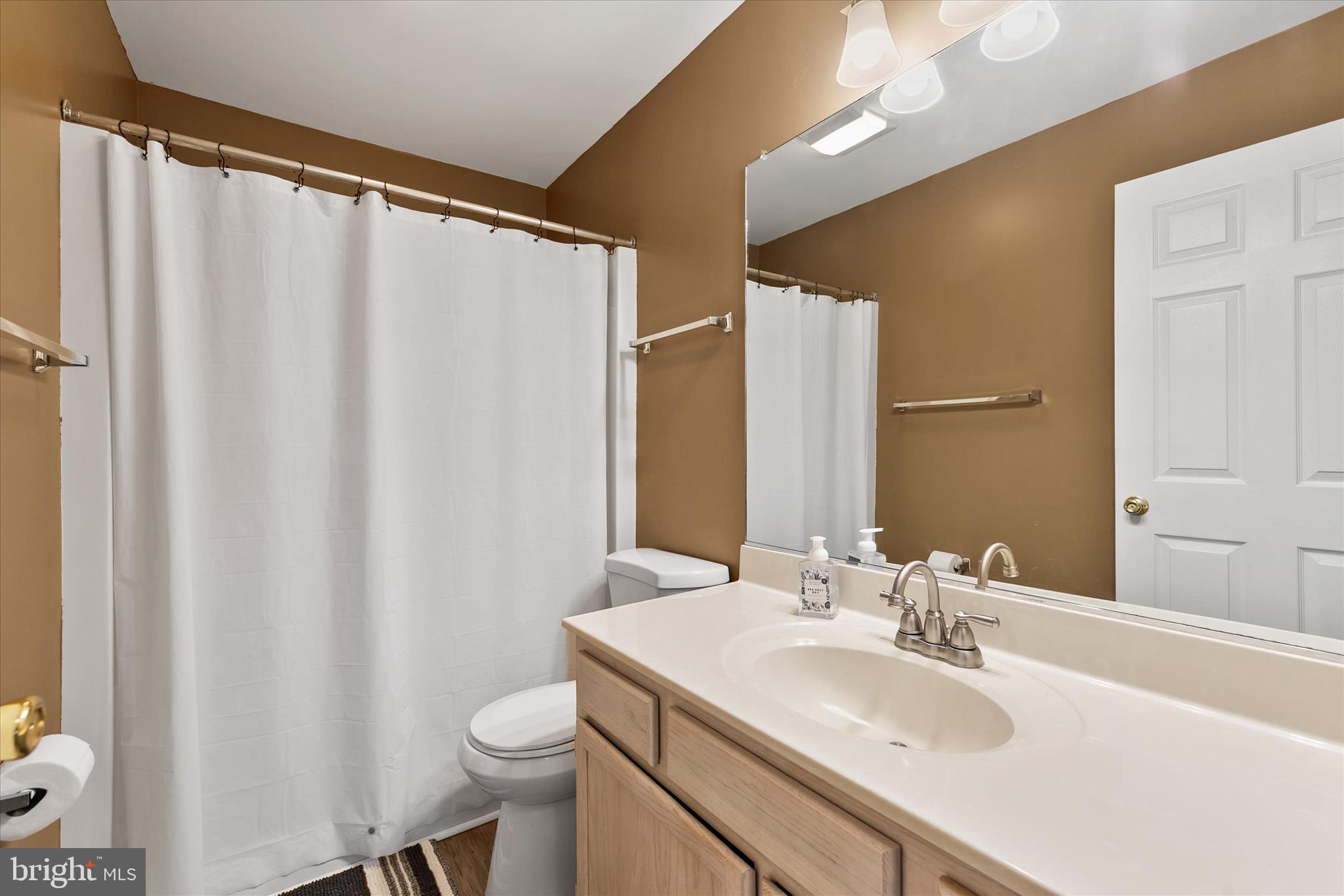 11423 Manklin Creek Road, Unit 1 Ocean Pines, MD 21811 - Photo 17 of 40 a bathroom with a sink toilet and mirror