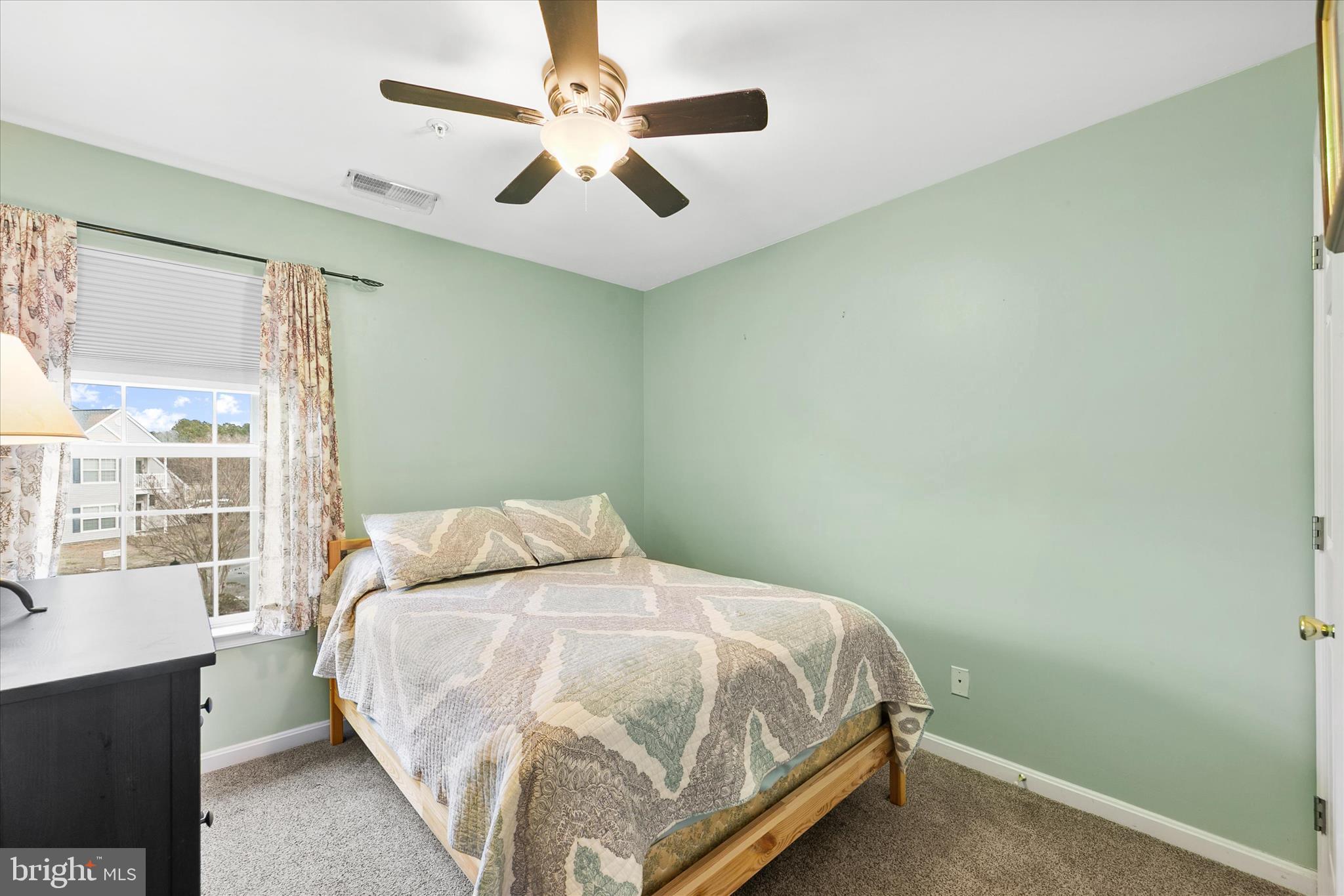 11423 Manklin Creek Road, Unit 1 Ocean Pines, MD 21811 - Photo 18 of 40 a bedroom with a bed and a large window