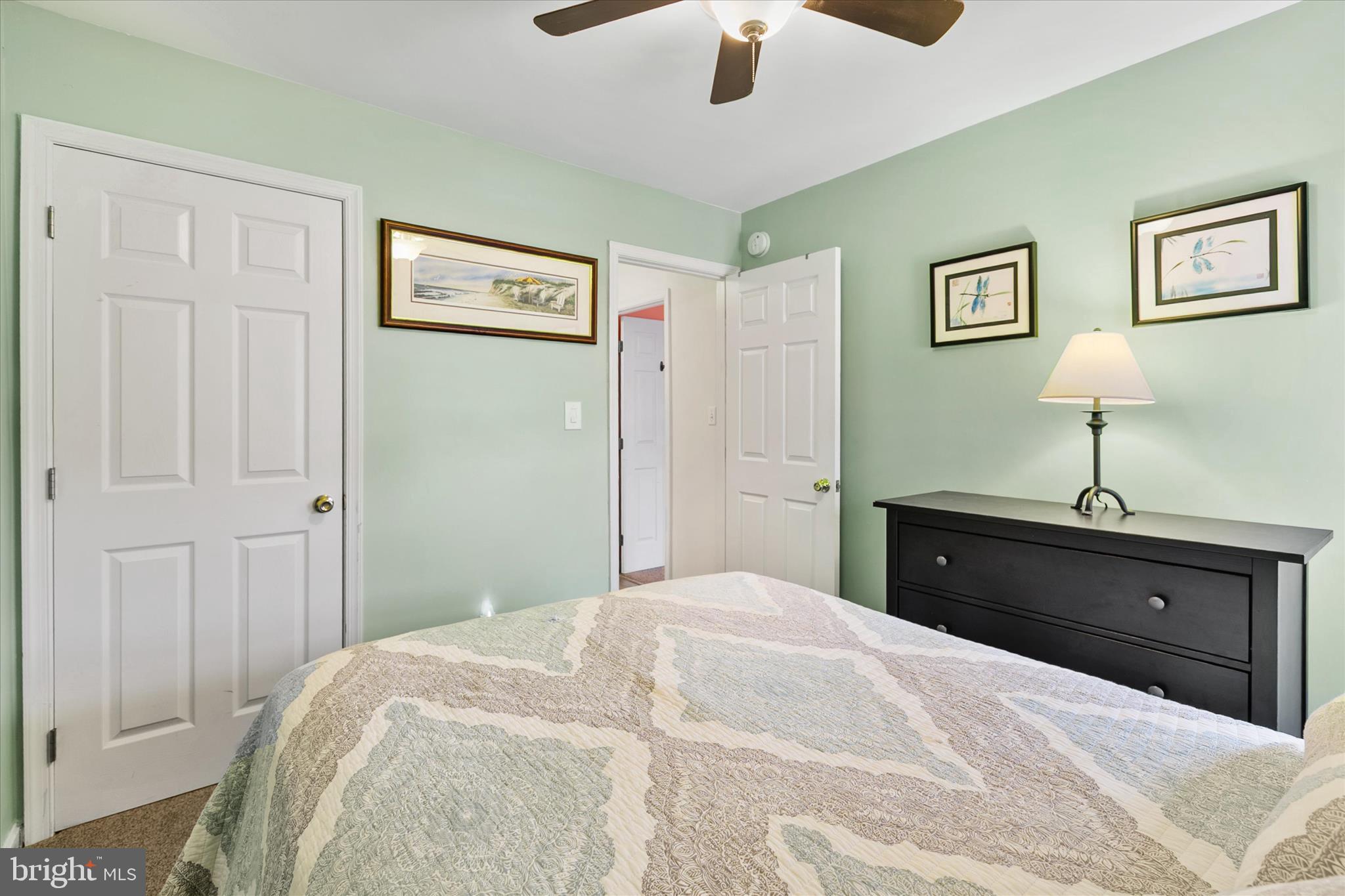 11423 Manklin Creek Road, Unit 1 Ocean Pines, MD 21811 - Photo 19 of 40 a bedroom with a bed and a chandelier