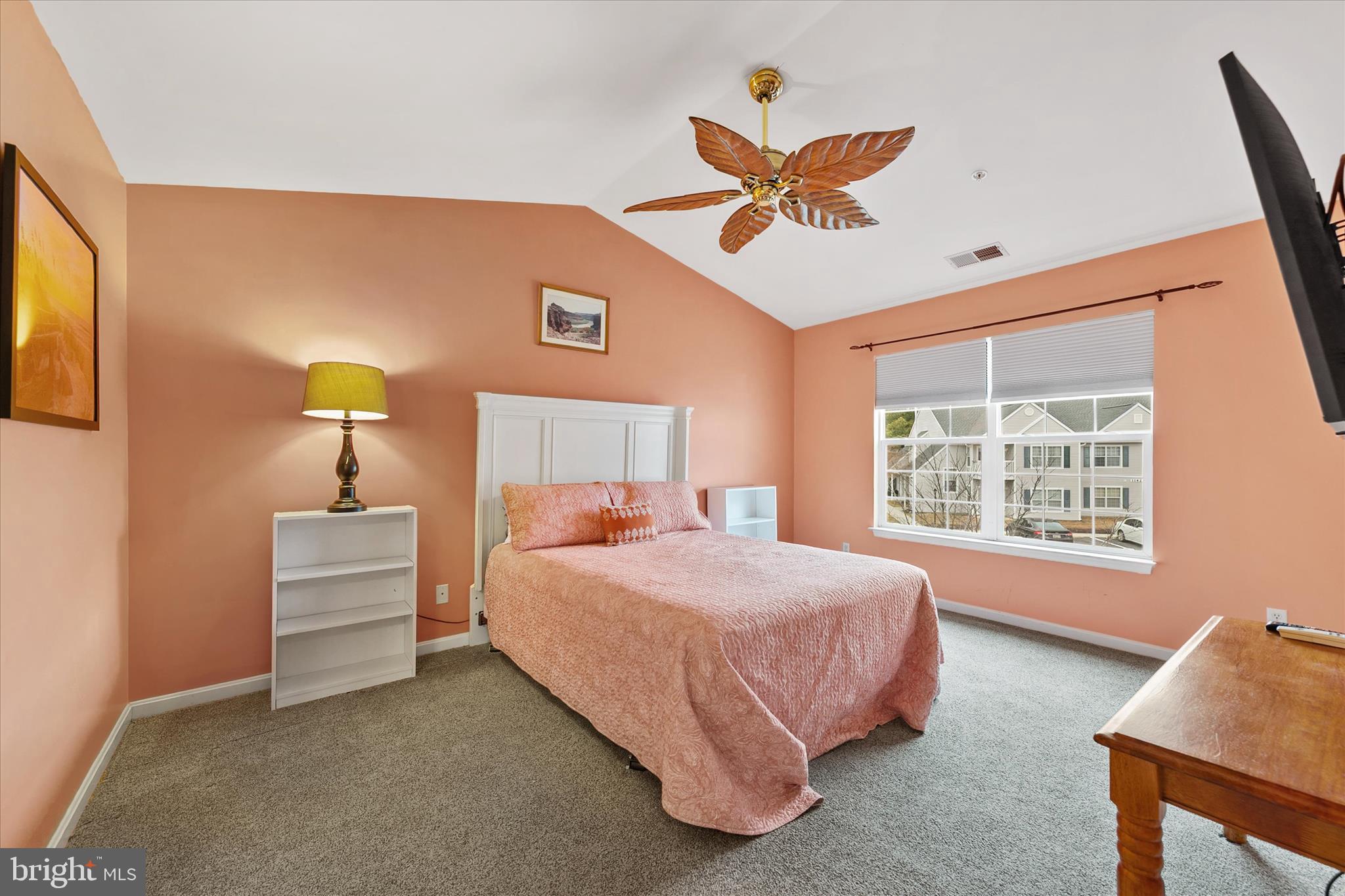 11423 Manklin Creek Road, Unit 1 Ocean Pines, MD 21811 - Photo 20 of 40 a bedroom with a bed and a chandelier