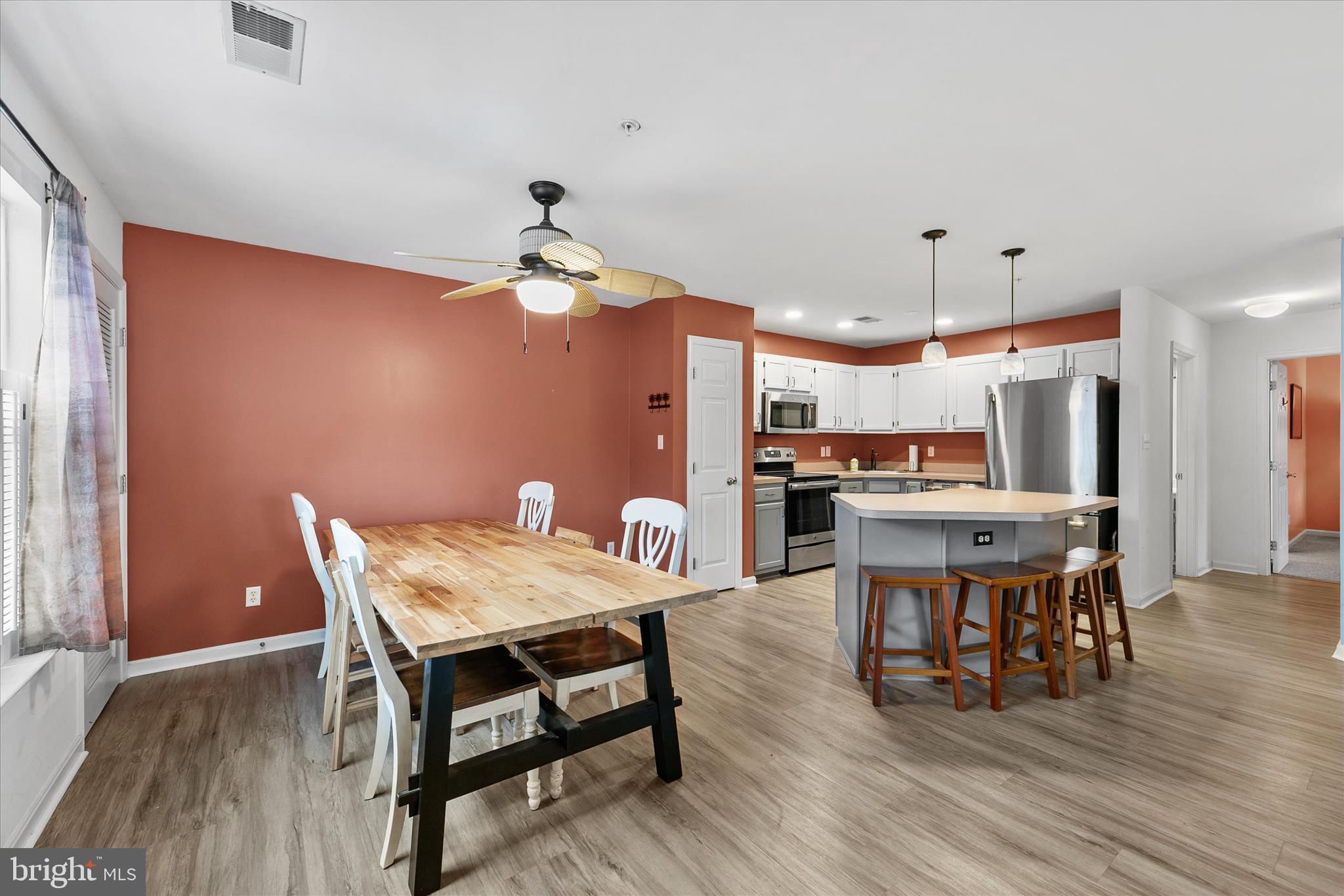11423 Manklin Creek Road, Unit 1 Ocean Pines, MD 21811 - Photo 2 of 40 a view of a dining room with furniture and wooden floor