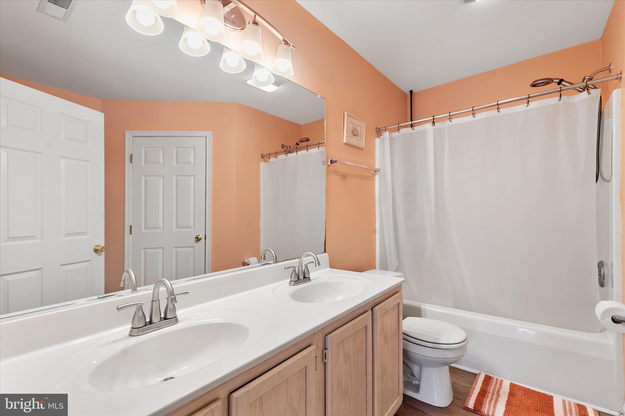 11423 Manklin Creek Road, Unit 1 Ocean Pines, MD 21811 - Photo 24 of 40 a bathroom with a sink a toilet and shower
