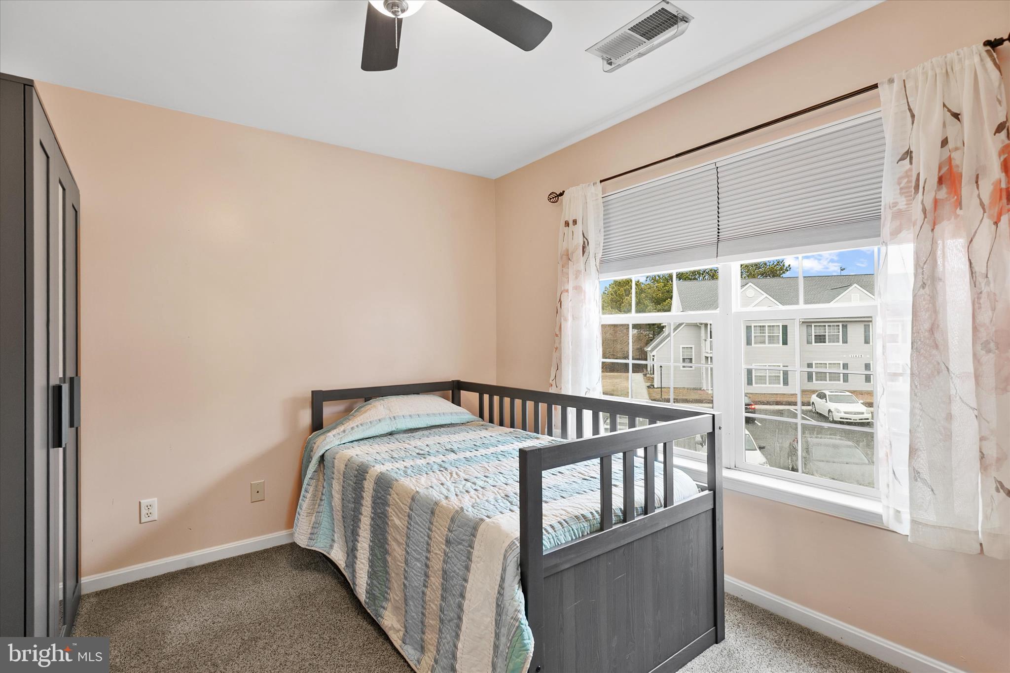 11423 Manklin Creek Road, Unit 1 Ocean Pines, MD 21811 - Photo 25 of 40 a bedroom with a bed and wooden floor