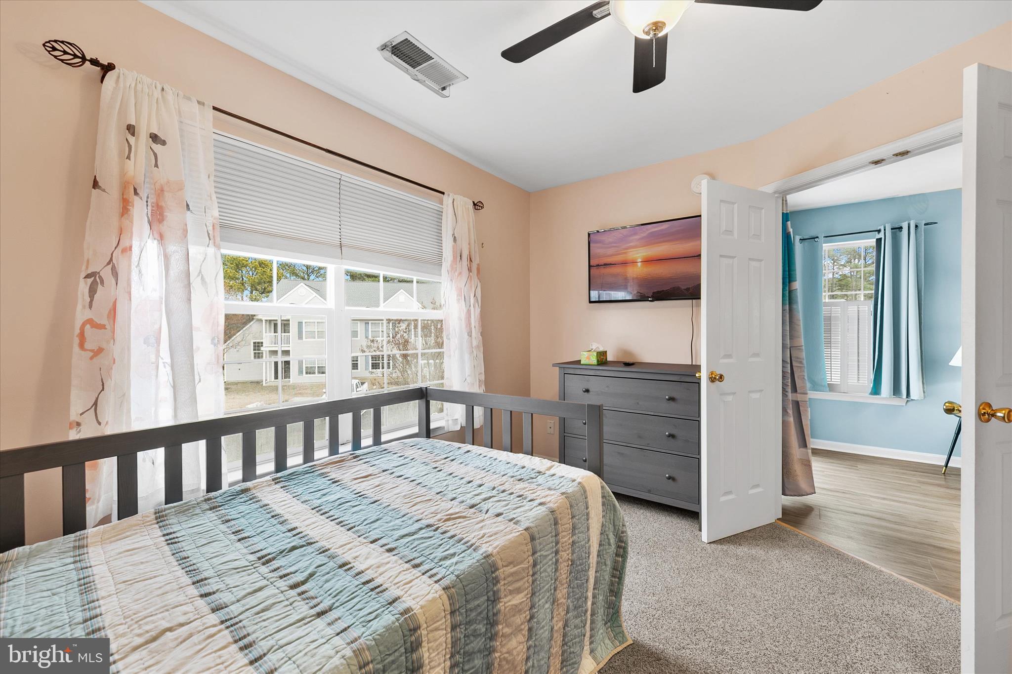 11423 Manklin Creek Road, Unit 1 Ocean Pines, MD 21811 - Photo 27 of 40 a bedroom with a large bed and a flat tv screen on dresser