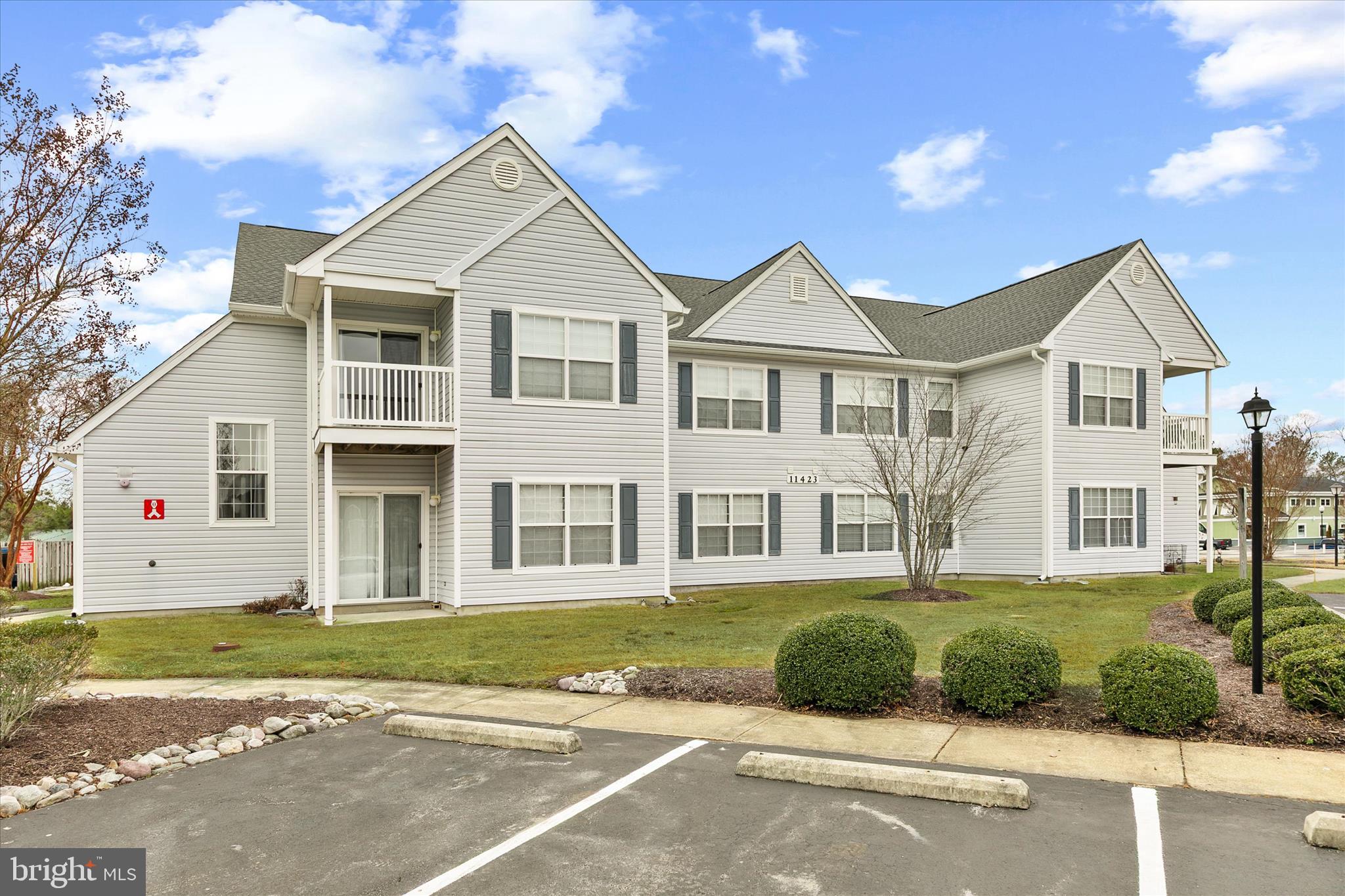 11423 Manklin Creek Road, Unit 1 Ocean Pines, MD 21811 - Photo 34 of 40 a front view of a house with a yard