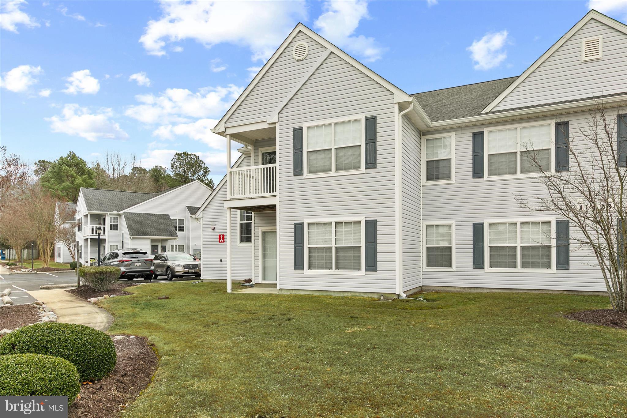 11423 Manklin Creek Road, Unit 1 Ocean Pines, MD 21811 - Photo 35 of 40 a view of a white house with a yard