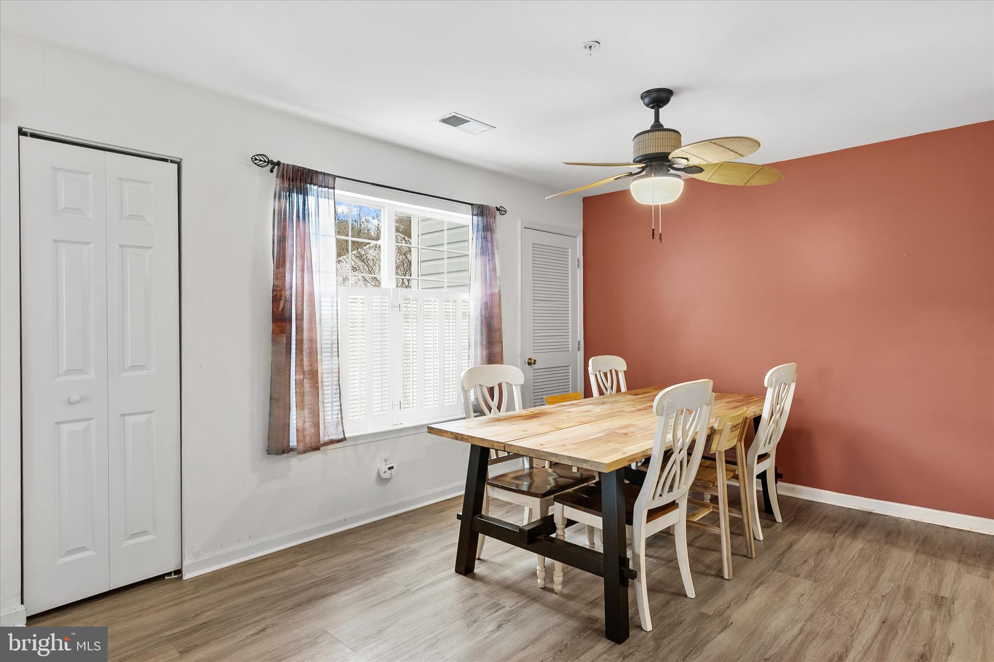 11423 Manklin Creek Road, Unit 1 Ocean Pines, MD 21811 - Photo 4 of 40 a dining room with furniture a chandelier and wooden floor
