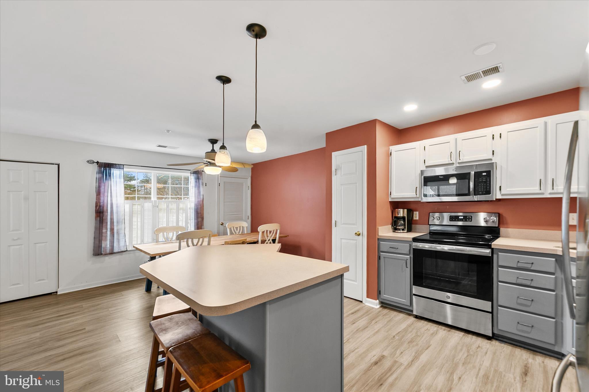 11423 Manklin Creek Road, Unit 1 Ocean Pines, MD 21811 - Photo 7 of 40 a kitchen with stainless steel appliances a stove a sink a microwave a refrigerator and cabinets