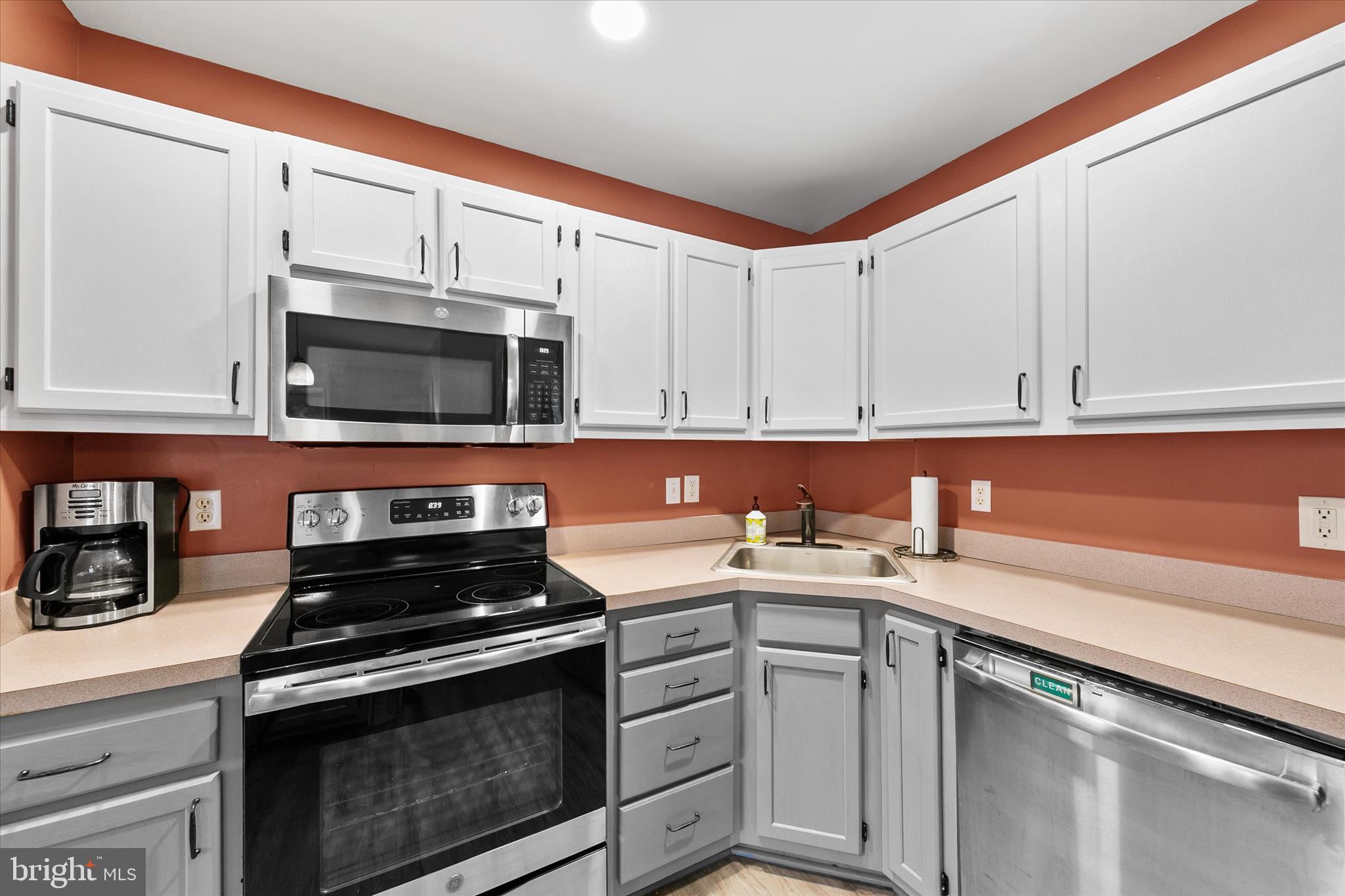 11423 Manklin Creek Road, Unit 1 Ocean Pines, MD 21811 - Photo 8 of 40 a kitchen with a sink stove and microwave