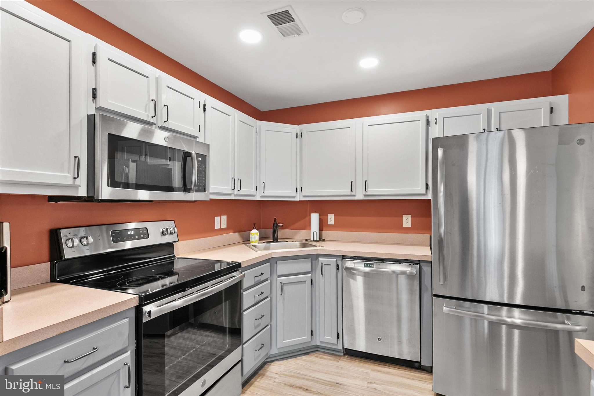 11423 Manklin Creek Road, Unit 1 Ocean Pines, MD 21811 - Photo 10 of 40 a kitchen with stainless steel appliances a stove microwave and refrigerator