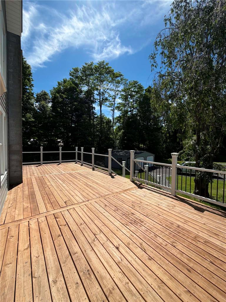 164 Sand Spring Road Cresco, PA 18326 - Photo 15 of 60 A spacious wooden deck provides an elevated outdoor retreat with scenic views.