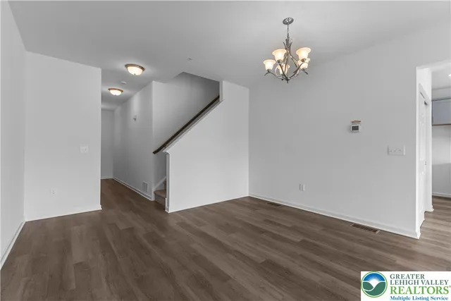 a view of an entryway with wooden floor